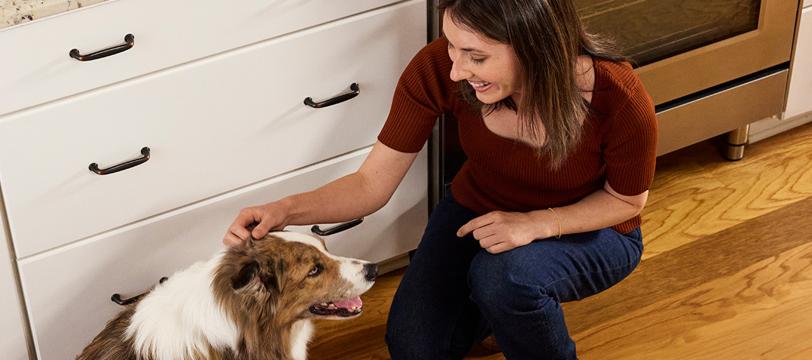 A woman petting a dog