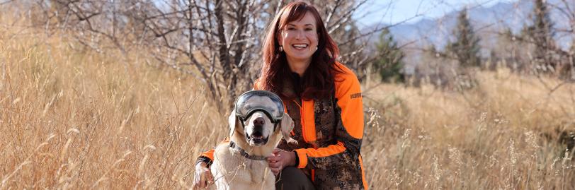 Dr Ruth Ann Image with Dog in a Field