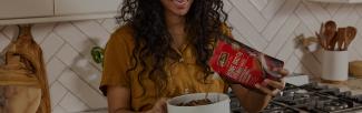 A woman pouring a bone broth into a bowl