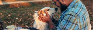 Man with dog at table for a BBQ-4-Good