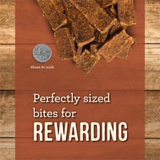 Slow-Cooked BBQ Texas Style rectangular dog jerky treats next to a quarter for scale on a brown background with text that says “Perfectly size bites for rewarding.” 