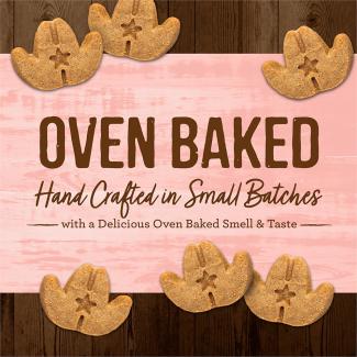 Oven Baked Cowboy Cookout leaf-shaped dog treats on a pink background that says “Oven baked hand crafted in small batches with a delicious oven baked smell & taste.” 