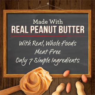 Peanut butter and a chalk board with the words “Made with real peanut butter. With real, whole foods. Meat free. Only 7 simple ingredients.” 